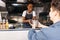 Young woman in apron working at food truck. Small business owner giving takeaway packaged food to customer