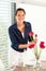 Young woman arranging flowers dinner table