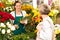 Young woman arranging flowers shop market selling