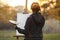 Young woman artist in nature drawing a picture on canvas on an easel in nature