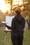 Young woman artist in nature drawing a picture on canvas on an easel in nature