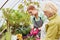 Young woman as a gardener trainee and elderly florist