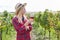 Young woman as a winegrower with a glass of red wine