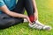 Young woman asian have accident ankle twist sprain in sport exercise jogging, selective focus