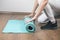 young woman assembles exercise mat