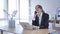 Young Woman Attending Call at Work, Talking on Phone