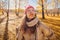 Young woman in the autumn weather in warm clothes and hats