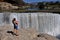 Young woman with baby at waterfall