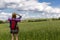 Young woman with backpack hiking in the countryside. Stress free travel concept.