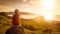 Young woman with backpack sitting on cliff and looking to a suns