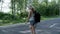 Young woman with backpack and sunglasses crossing the road