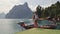 Young woman backpacker enjoy landscape view of lake and mountain with fog layer morning, Asia, Vintage tone.