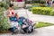 A young woman backpacker sitting on a bench using her mobile and resting her legs on two backpacks in a square in Split, Croatia