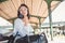 Young woman with bag and backpack waiting to train.