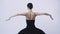 Young woman ballerina in black dress from the back
