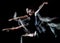 Young woman ballerina  dancer dancing isolated black background light painting