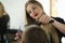 Young Woman Barber Cutting Client Hair in Salon