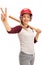 Young woman with a baseball bat and a helmet making a peace sign