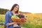 Young woman with basket of harvest of blue and green grapes