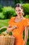 Young woman with baskets of fruit and vegetables