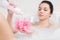 Young woman in a bath with foam sponge in hand