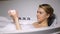 Young woman in bath washing body with soap, daily beauty procedure, freshness