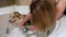 A young woman bathes a small corgi puppy at home