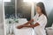 Young woman in bathroom washing her hands