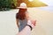 A young woman on a beach holds a man`s hand