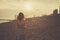 Young woman on the beach at sunset