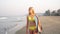 Young woman on the beach with a surf. Girl in a bikini swimsuit with a surfboard