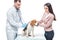 young woman with beagle and veterinarian examining it by stethoscope