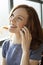 Young Woman with Beautiful Blue Eyes Talking on Cell Phone