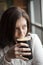 Young Woman with Beautiful Brown Eyes Drinking a Pint of Stout