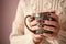 Young woman with beautiful manicure holding cup of coffee, closeup