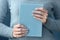 Young woman with beautiful manicure holding notebook, closeup