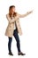 Young Woman In Beige Coat Is Standing, Pointing And Laughing