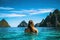 Young woman in bikini enjoying the beauty of the tropical island of Phi Phi, Thailand, Young woman swimming in clear sea water in