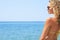Young woman in a bikini enjoying the ocean breezes