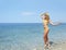 Young woman in a bikini enjoying the ocean breezes