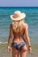 Young woman in bikini with a hat on the Mediterranean beach in Tunisia