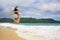 Young woman in bikini jumping at Rincon beach, Samana peninsula