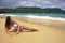 Young woman in bikini laying at Rincon beach, Samana peninsula