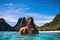 Young woman in bikini relaxing in an infinity pool on a tropical island, Young woman swimming in clear sea water in lagoon and