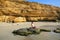 Young woman in bikini sitting at La Mina Beach in Paracas Nation