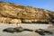 Young woman in bikini sitting at La Mina Beach in Paracas Nation