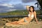 Young woman in bikini sitting at Las Galeras beach, Samana peninsula