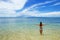 Young woman in bikini standing in clear water on Taveuni Island, Fiji