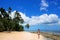 Young woman in bikini walking on the beach at Makaha`a island ne