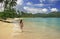 Young woman in bikini walking at Rincon beach, Samana peninsula